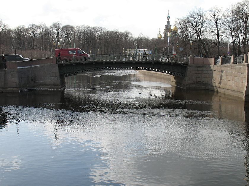 Река Фонтанка, вид на Первый Инженерный мост и начало реки Мойки. Ранняя весна, мост, голые деревья, люди, машины.